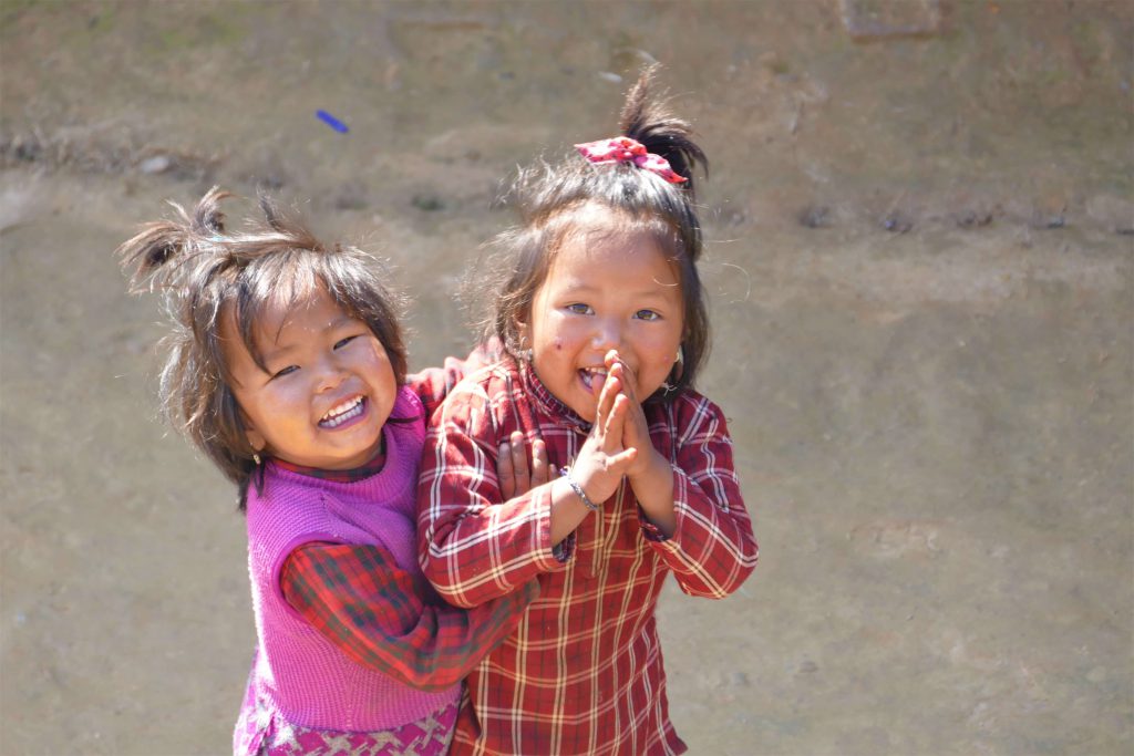 Family adventure in Nepal – children greeting namaste